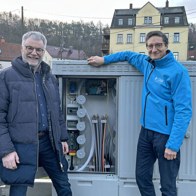 Oberbürgermeister Uwe Rumberg (l.) und FSW-Geschäftsführer Matthias Leuschner an der neuen Schaltzentrale fürs Glasfaserinternet in Saalhausen
