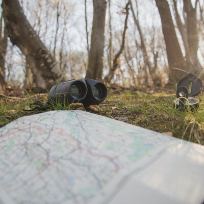 ground-with-open-map-compass-binoculars